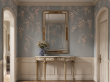 Hand-carved gilded Venetian mirror with arched Venetian frame, styled in an entryway setting.