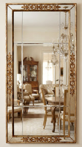 Hand-carved gilded Venetian mirror with arched Venetian frame, styled in an entryway setting.