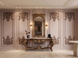 Hand-carved gilded Venetian mirror with scrolled frame, styled in an entryway setting.