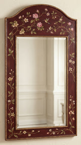 Hand-carved gilded Venetian mirror with arched scrolled frame, styled in a dining room setting.
