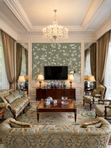 Hand-painted natural mulberry silk wallcovering featuring the Peony Pavilion Silk motif on silk ground, shown in a dining room application.