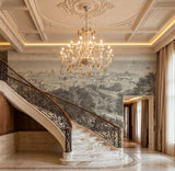 Hand-painted panelled mural wallcovering depicting grand staircase landscape in muted tones, installed across a stairwell.