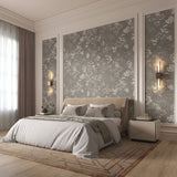 Vinyl-print wallcovering in a fine botanical sprig motif on warm parchment ground, shown applied to a bedroom wall.
