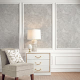 Vinyl-print wallcovering in a tone-on-tone silver-grey damask scroll motif, shown applied to a wall panel.