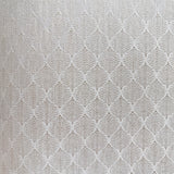 Vinyl-print wallcovering in a bright ivory diamond-arrow weave motif, shown as a product swatch.
