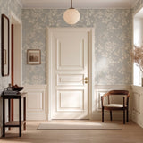 Vinyl-print wallcovering in a grey-on-white cherry-blossom branch motif, shown applied to a wall panel.
