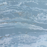 Vinyl-print wallcovering in a powder-blue abstract marbled wave motif, shown applied to a bedroom feature wall.