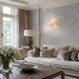 Plain tonal textured vinyl-backed wallcovering in mottled coarse-grain finish, grey ground, shown applied to a living-room wall.