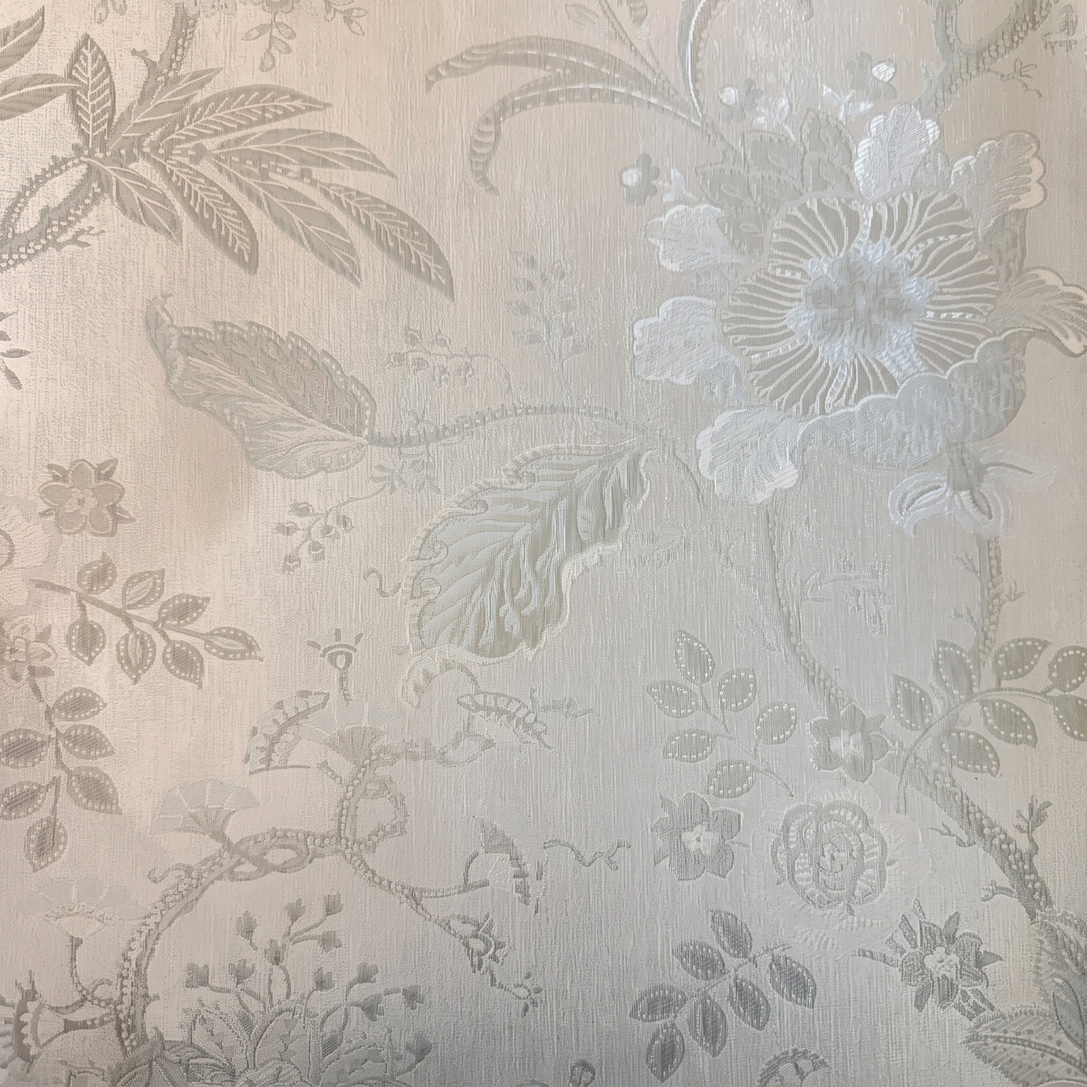 Vinyl-print wallcovering in a tone-on-tone ivory jacquard floral motif, shown as a product swatch.